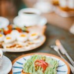 Delicious avocado toast and breakfast spread, beautifully styled on a rustic table.